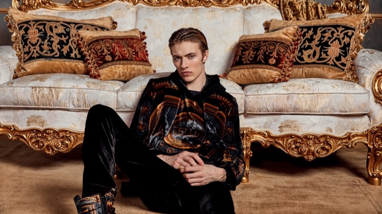 Relaxing, Lucky Blue Smith wears Kith x Versace.
