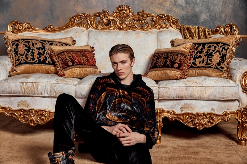 Relaxing, Lucky Blue Smith wears Kith x Versace.