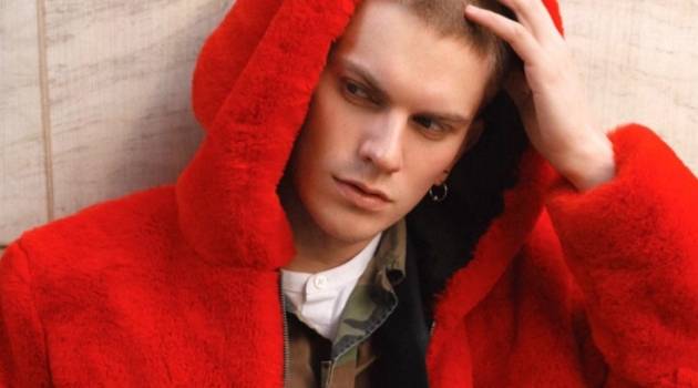 Alexander Morel Sports Statement Style for Shoot Session Starring in a series of images, Alexander Morel models a red fur jacket by PEACEMINUSONE with a Stüssy camouflage print jacket, Prada trousers, Fila sneakers and a Ralph Lauren shirt.