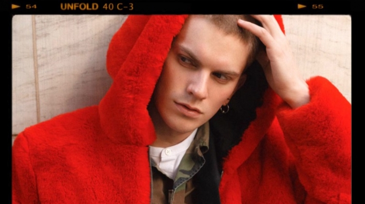 Starring in a series of images, Alexander Morel models a red fur jacket by PEACEMINUSONE with a Stüssy camouflage print jacket, Prada trousers, Fila sneakers and a Ralph Lauren shirt.