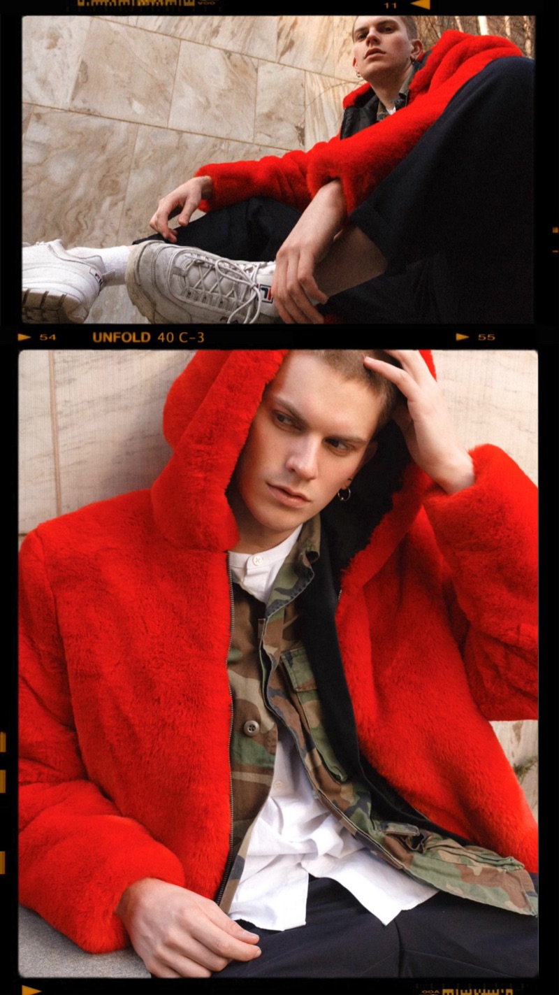 Starring in a series of images, Alexander Morel models a red fur jacket by PEACEMINUSONE with a Stüssy camouflage print jacket, Prada trousers, Fila sneakers and a Ralph Lauren shirt.