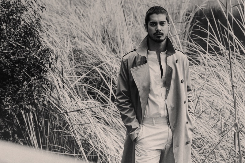 Actor Avan Jogia dons a H&M trench with a SCYLT shirt, and COS trousers.