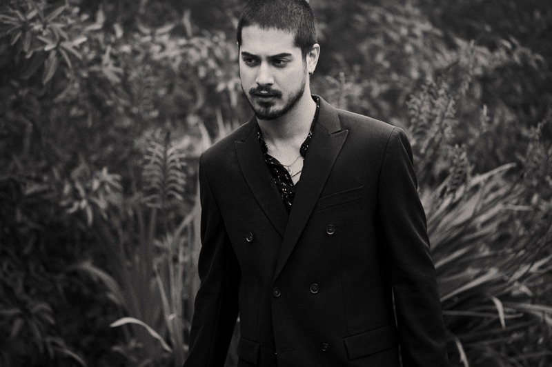 Avan Jogia wears a H&M shirt with a Calvin Klein double-breasted suit jacket and his own necklaces.