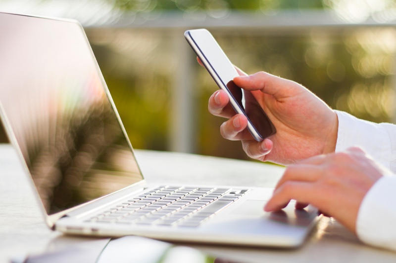 Businessman with Laptop and Smartphone