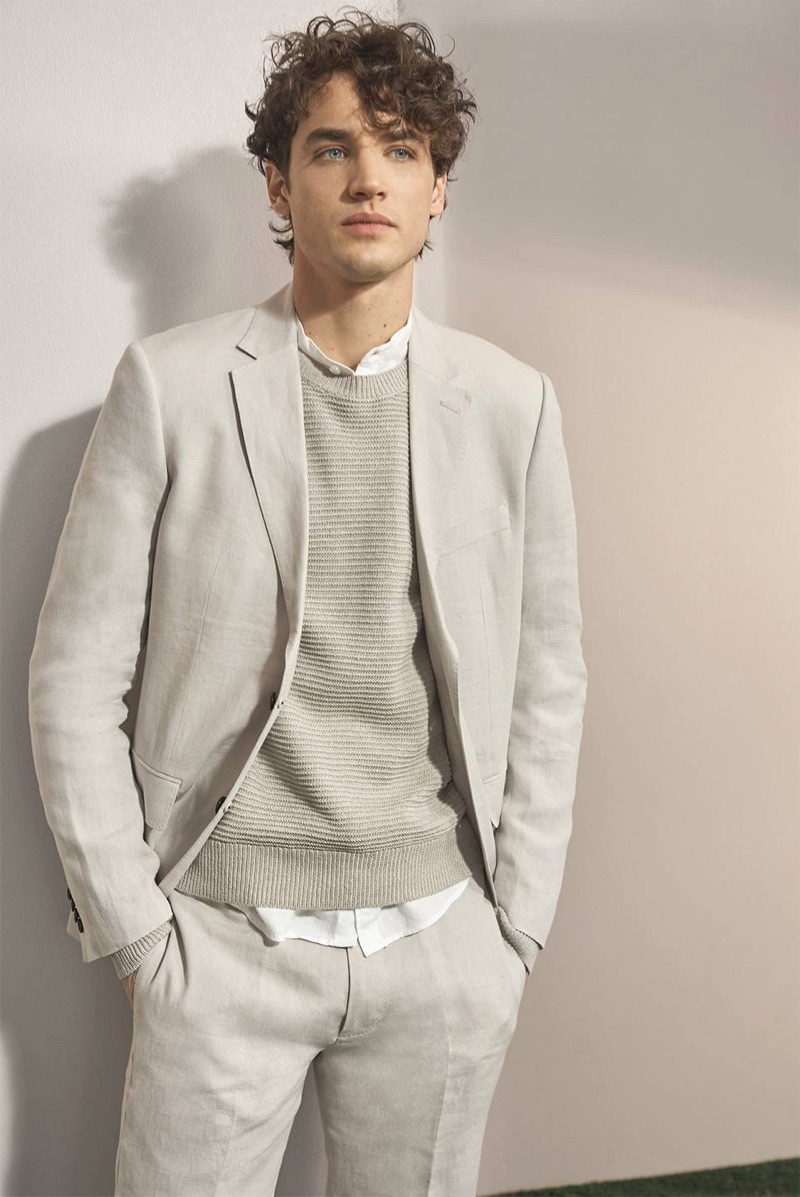 A chic spring vision, Federico Novello wears a Club Monaco linen blazer, crew, band-collar shirt, and trousers.