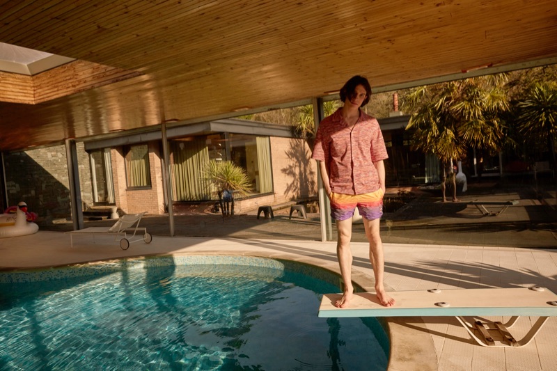 Captured poolside, Liam Gardner wears a Missoni shirt and swim shorts.