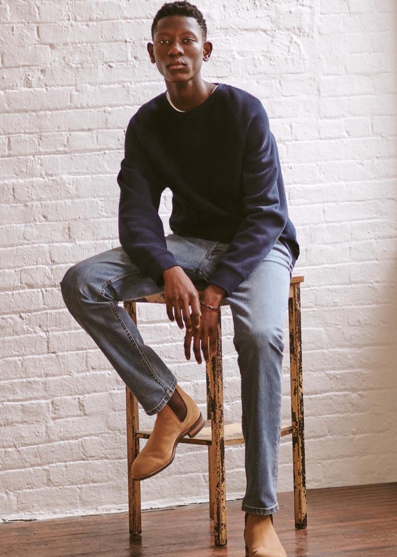 Lang Jobe sports an AMI tee, Vince sweatshirt, A.P.C. jeans, and R.M. Williams boots. He also wears Scosha bracelets.