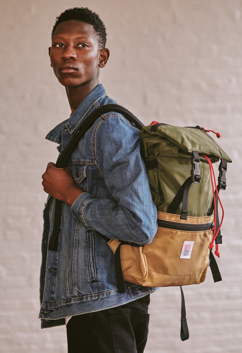 Going casual, Lang Jobe wears a LEvi's Red Tab denim jacket, Saturdays NYC tee, J Brand jeans, and a Topo Designs backpack. 