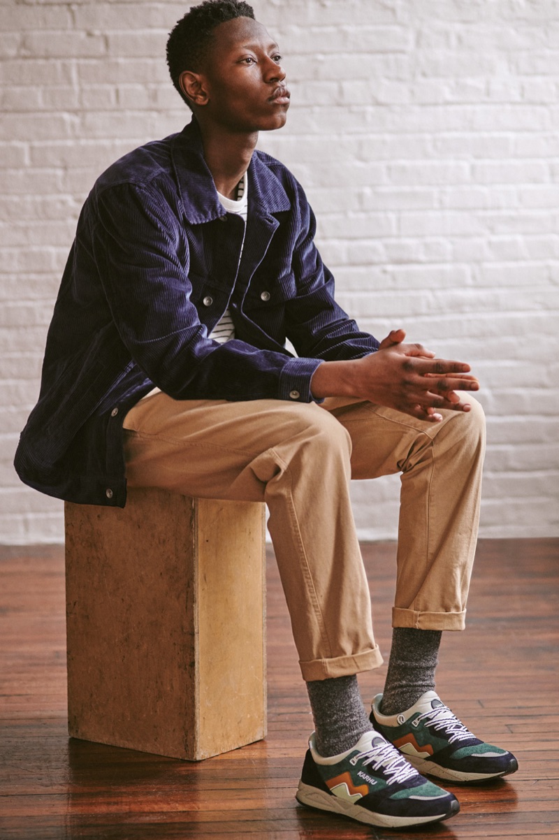 Connecting with East Dane, Lang Jobe dons a Rag & Bone stripe tee, Obey pants, albam corduroy utility jacket, Karhu sneakers, and Howlin' socks.