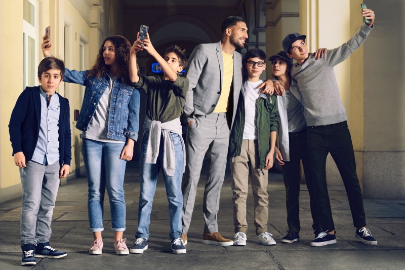 Emre Can charms in a H&M premium cotton t-shirt, skinny-fit blazer, and suit pants.