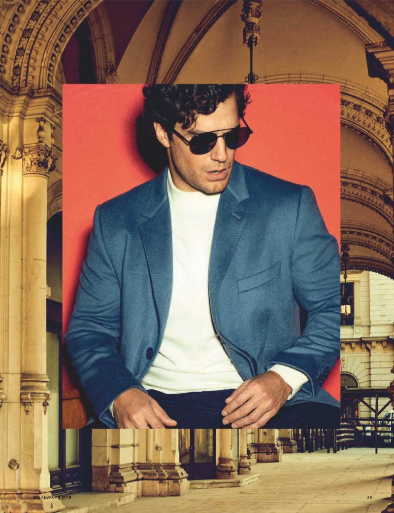 A cool vision, Henry Cavill rocks BOSS sunglasses with a sweater and trousers. He also dons a Dolce & Gabbana coat.