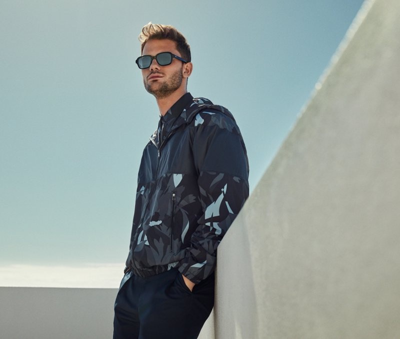 Embracing a graphic camouflage print, Jeremy Irvine wears a windbreaker from BOSS.