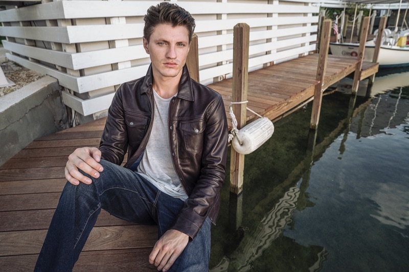 Model Eli Hall is in the spotlight as he dons a leather jacket and jeans from John Varvatos Star USA.