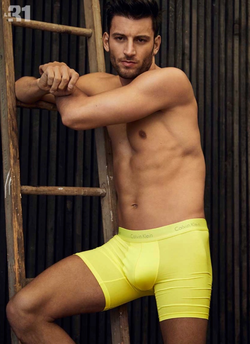 Making a colorful statement, Kevin Sampaio rocks yellow boxer briefs by Calvin Klein.
