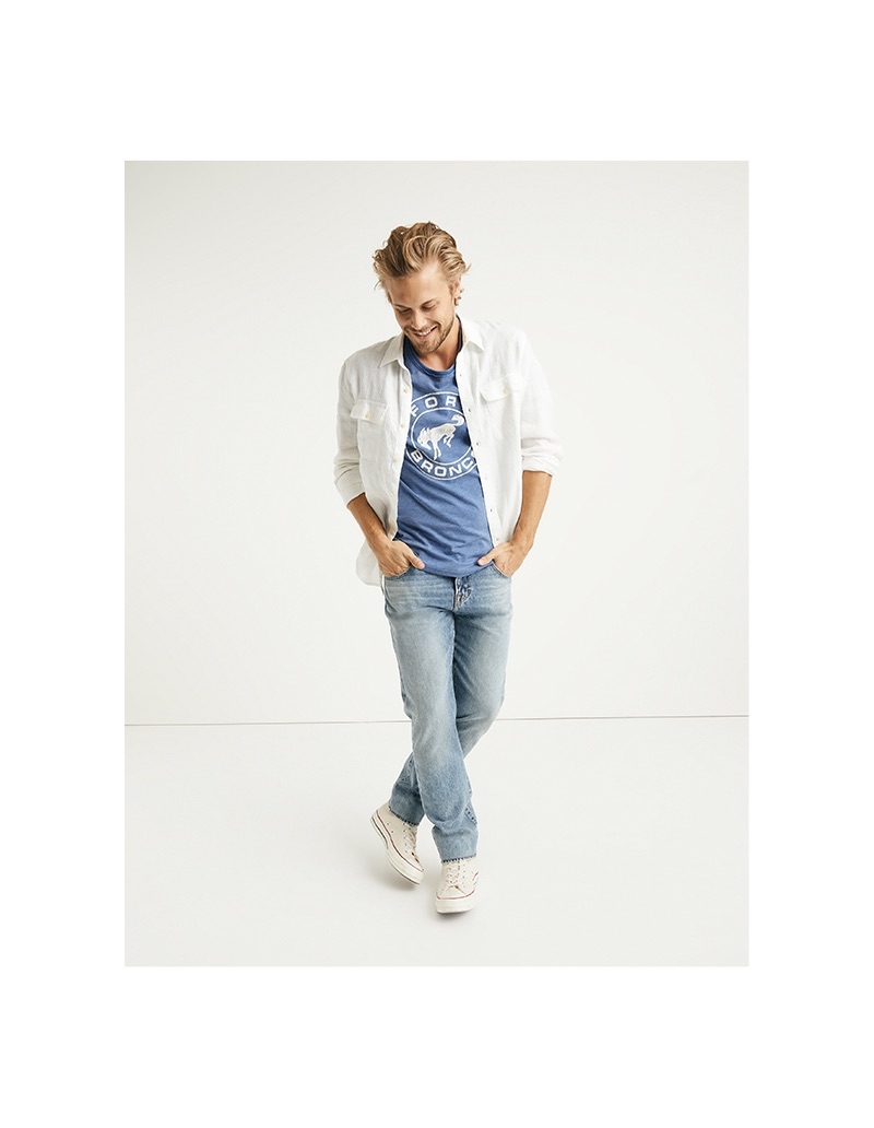 Layering, Christopher Mason sports a Lucky Brand Havana linen shirt, Ford Bronco t-shirt, and 110 skinny vertical stretch jeans.
