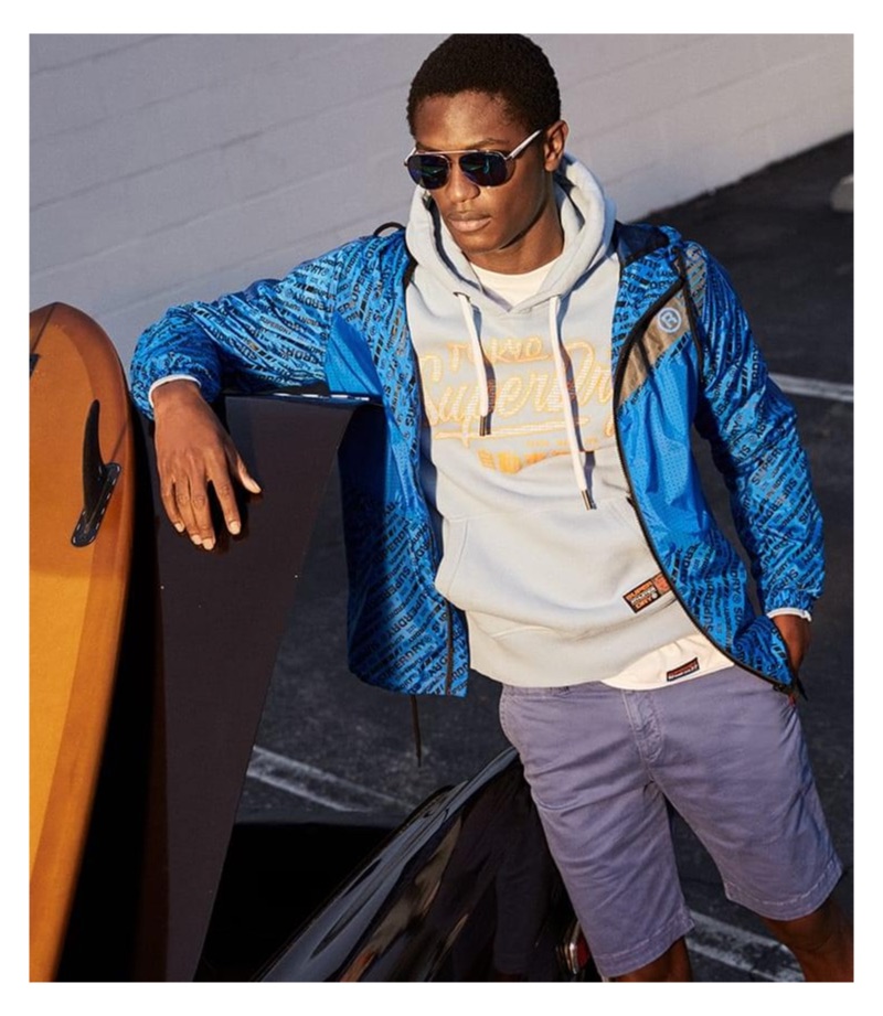 Hamid Onifade sports a Superdry logo graphic hoodie and jacket.