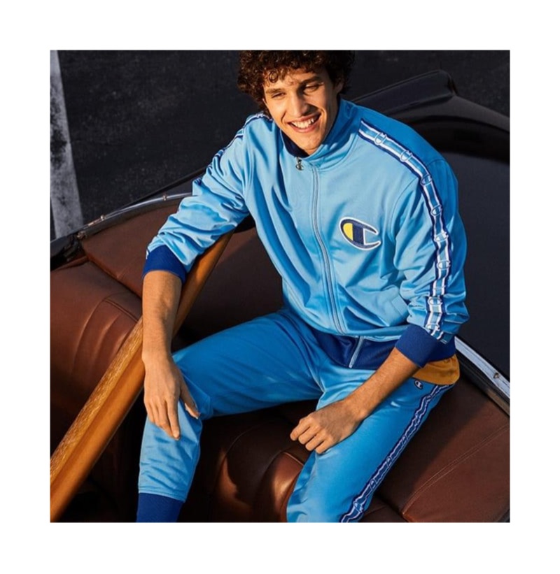 All smiles, Francisco Henriques wears a Champion track jacket and pants.