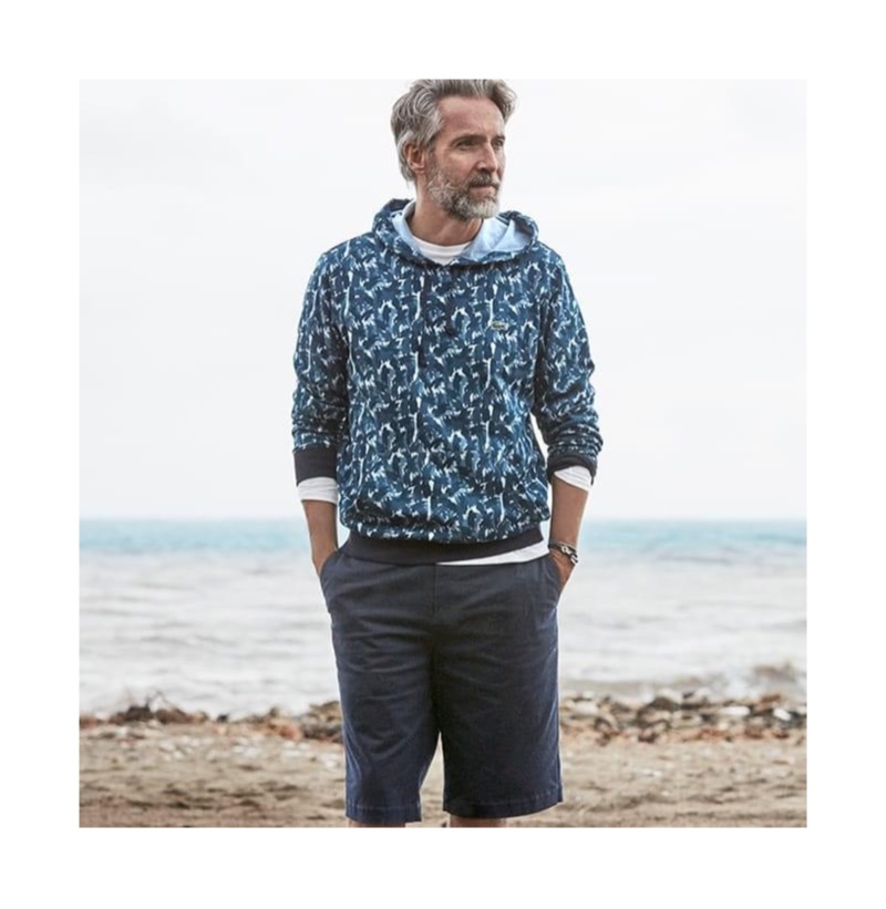 Ben Desombre sports a Lacoste printed hoodie with Bermuda shorts.