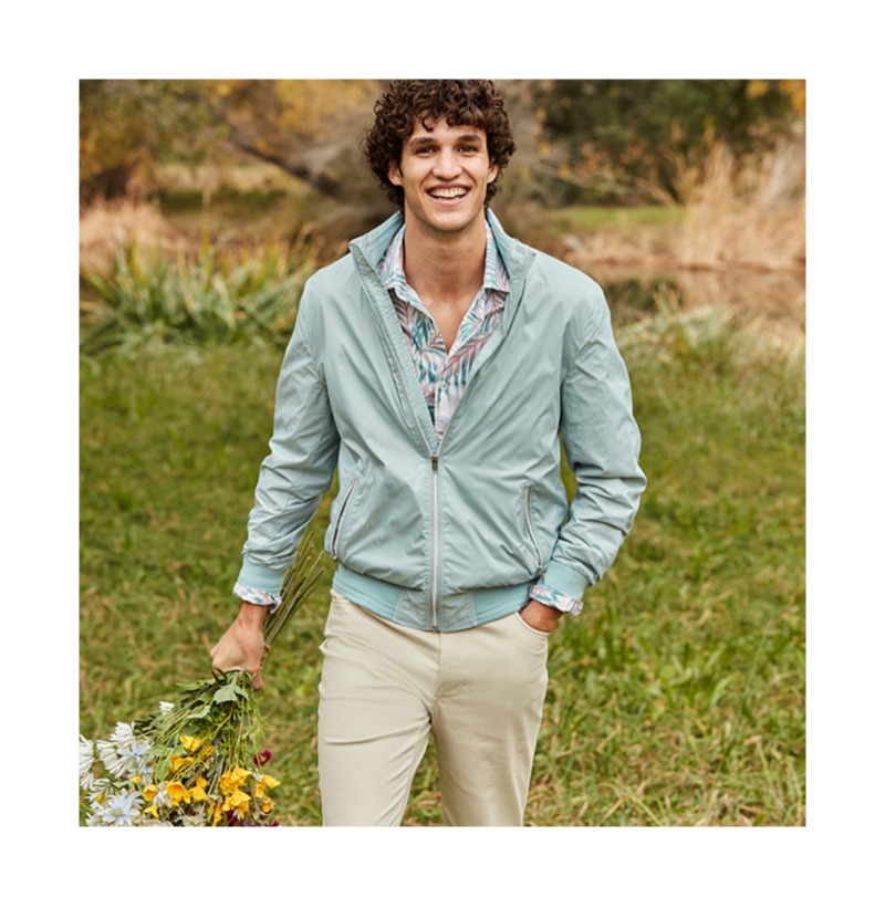 All smiles, Francisco Henriques dons a jacket and printed shirt from Macy's.