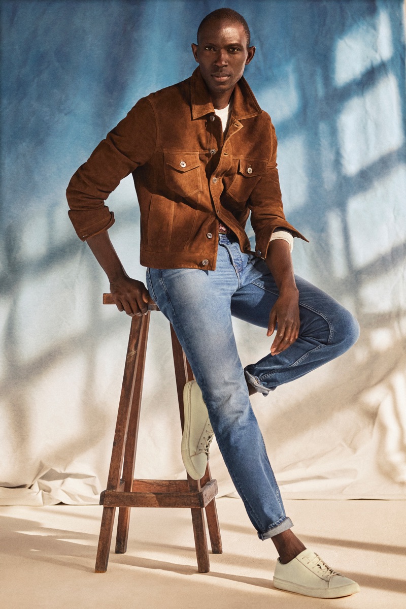 Light Denim: Armando Cabral sports a vintage-style jacket in brown suede with a light pair of Tim jeans from Mango.