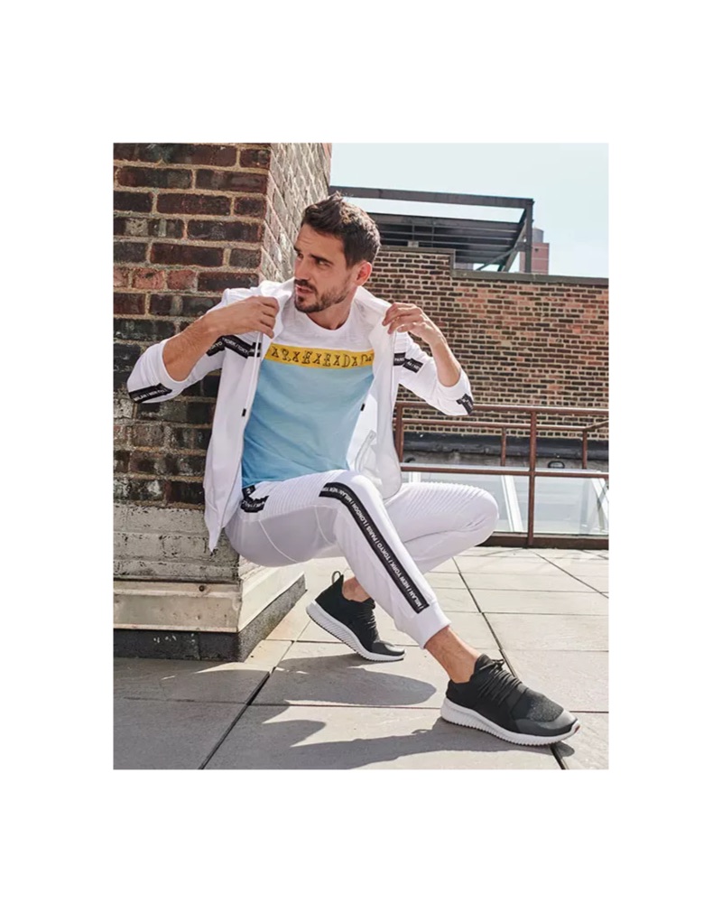 Arthur Kulkov goes sporty in a white tracksuit from Macy's.