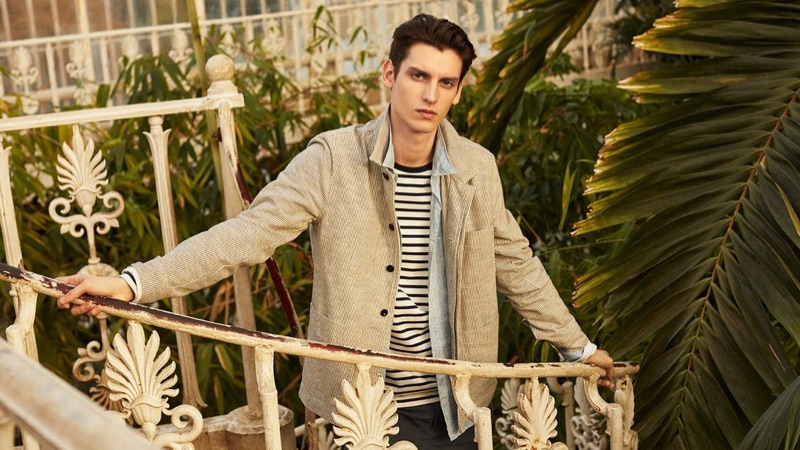 Anthony Gilardot wears a striped slub jacket, jersey t-shirt, shorts, and linen shirt by Mr P.