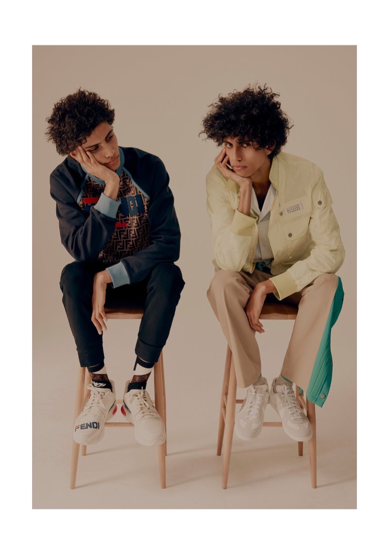 Left: Trent wears a Fendi sweatshirt, sweatpants, sneakers, and socks. Right: Piers sports a Maison Margiela shell jacket, oxford shirt, trousers, and sneakers.