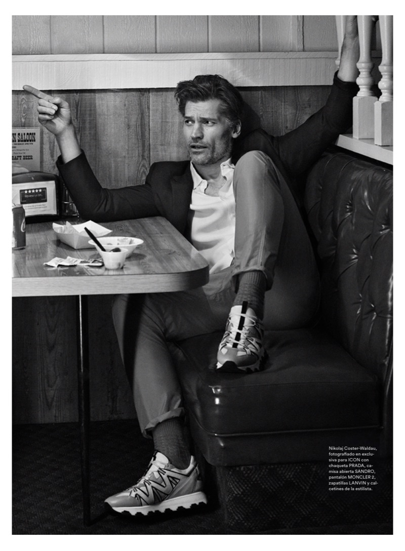 Actor Nikolaj Coster-Waldau sports a Sandro shirt, Prada suit jacket, Moncler 2 pants, and Lanvin sneakers.