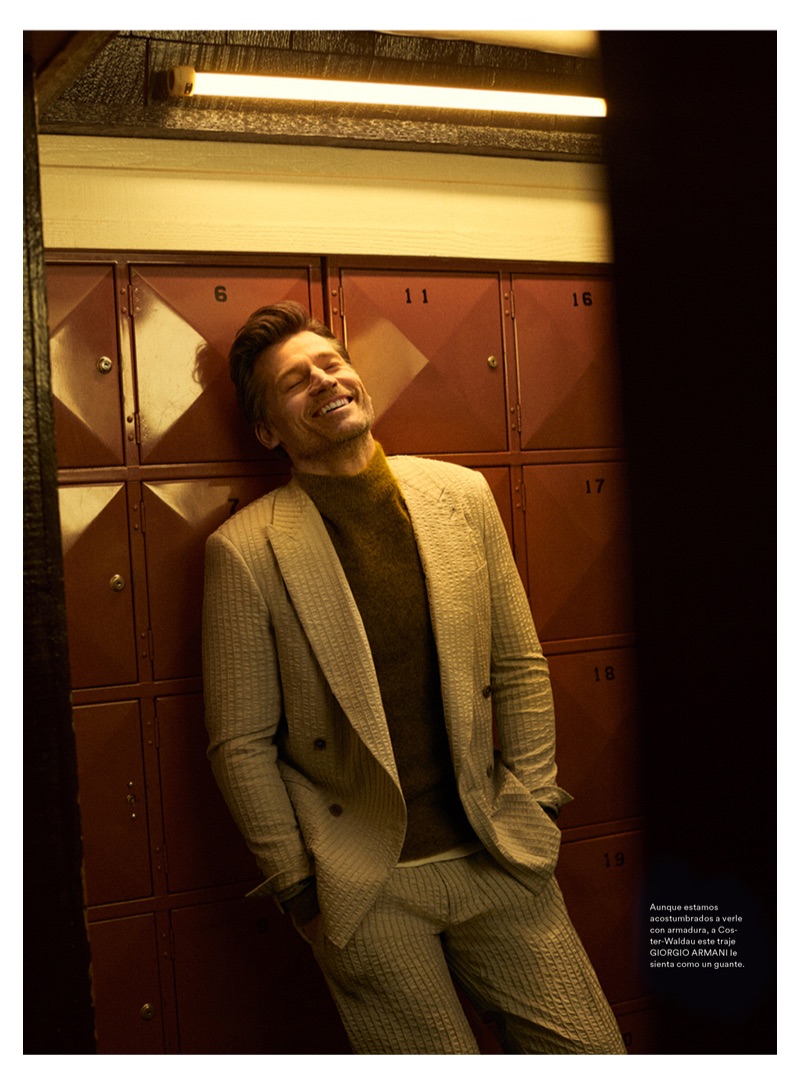 All smiles, Nikolaj Coster-Waldau wears a Giorgio Armani suit and sweater.