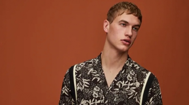 The New Neutrals: Paul François Dons Spring Styles for Scotch & Soda Mixing prints, Paul François wears a Hawaiian print shirt and pinstripe pleated trousers by Scotch & Soda.