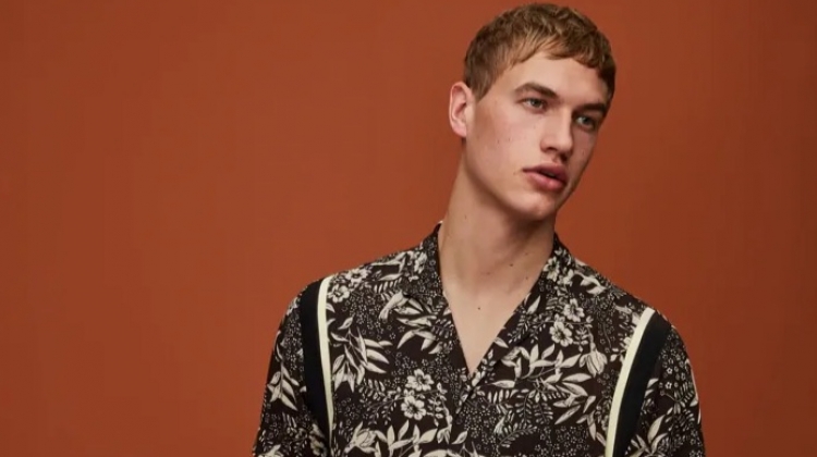 Mixing prints, Paul François wears a Hawaiian print shirt and pinstripe pleated trousers by Scotch & Soda.