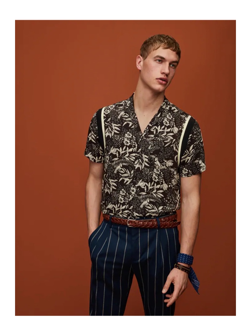 Mixing prints, Paul François wears a Hawaiian print shirt and pinstripe pleated trousers by Scotch & Soda.