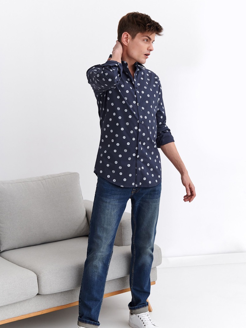 Sporting a patterned shirt and distressed denim jeans, Pawel Bednarek wears Top Secret.