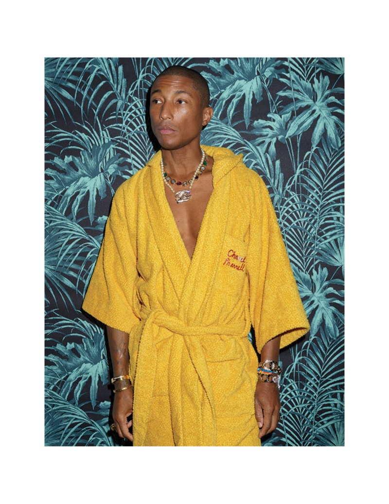 Donning a robe, Pharrell showcases his Chanel Pharrell collection.