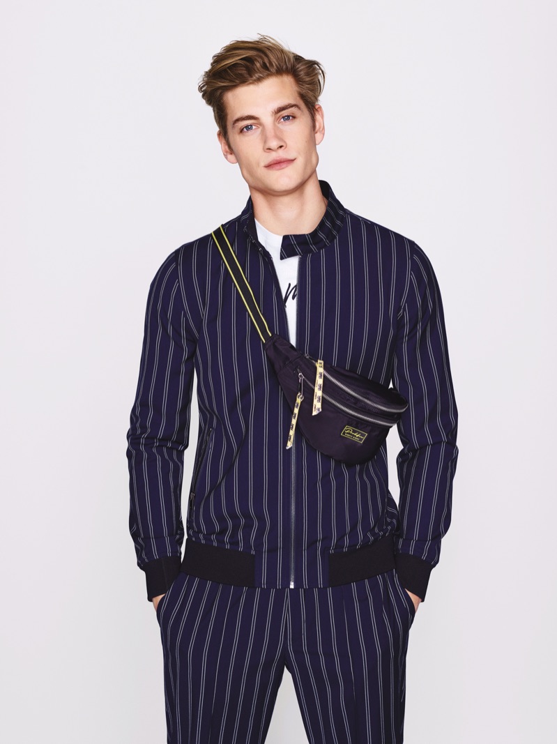 Front and center, Rob Knighton rocks a pinstripe number in navy from River Island.