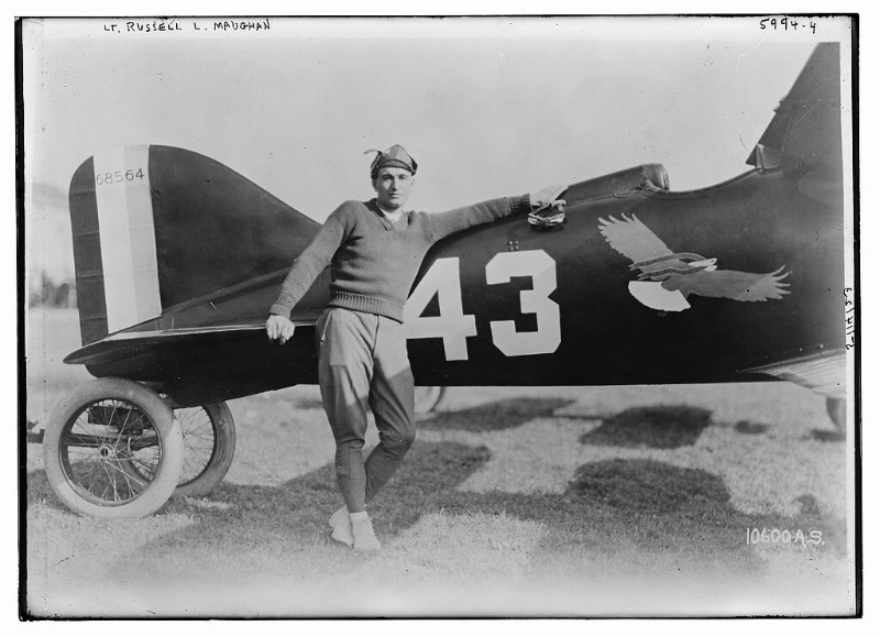 Sporting a casual sweater, Lt. Russell L. Maughan is photographed in the 1920s alongside a Curtiss R-6 Racer.