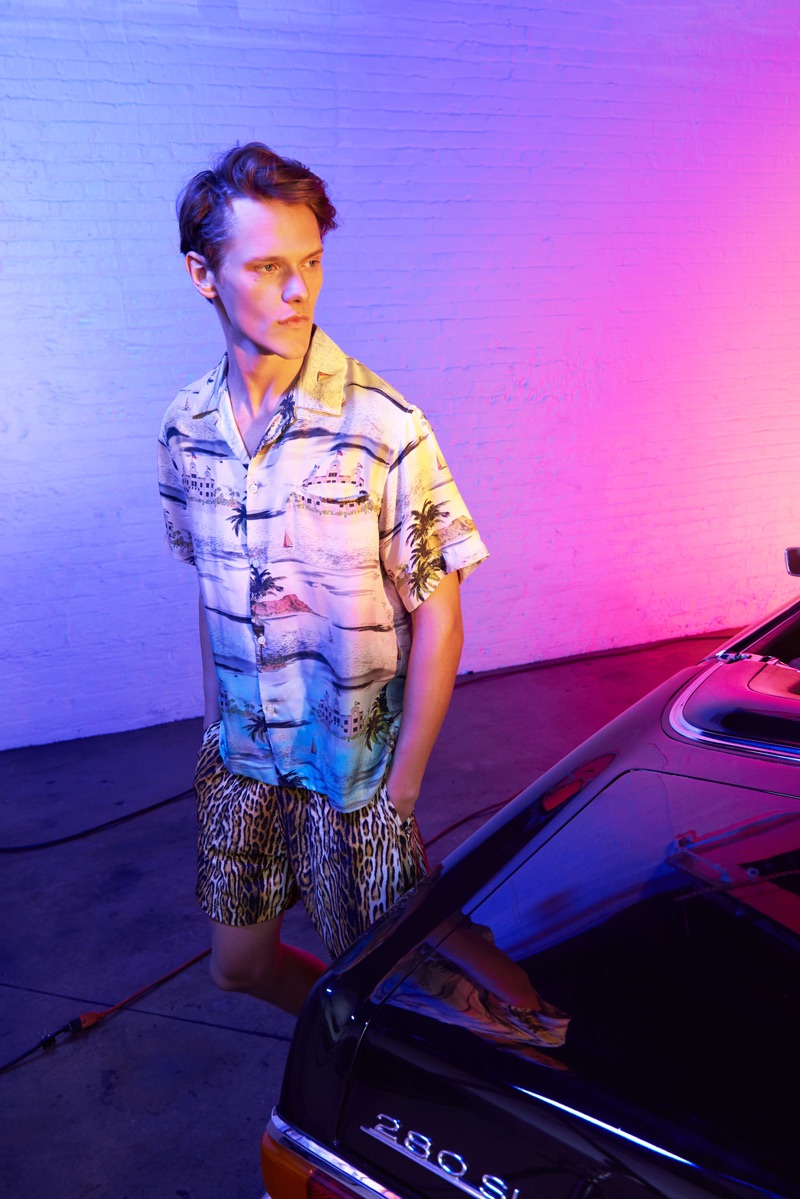 Ryan Keating sports an AMIRI Beverly Hills tropical shirt with leopard shorts.