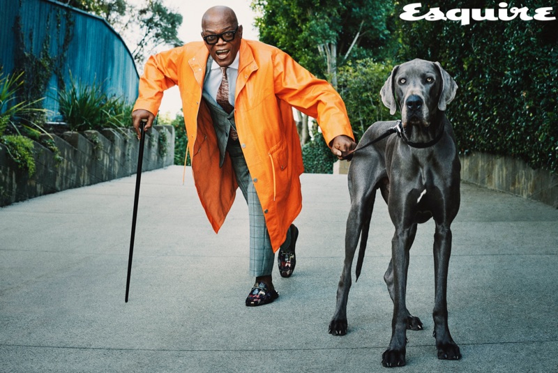 Actor Samuel L. Jackson dons a Hermès coat, Dries Van Noten tie, and Salvatore Ferragamo shoes. He also wears a shirt and suit by Versace with a Gucci cane.