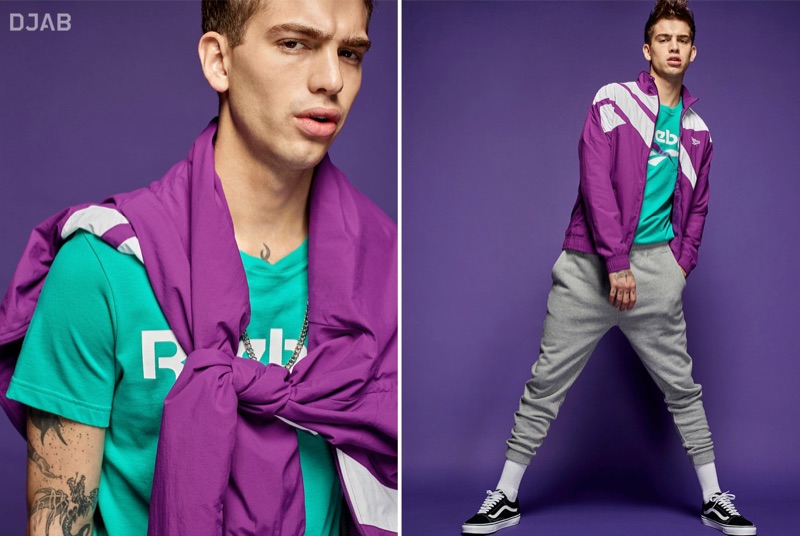 Model Jeremy Ruehlemann wears a Reebok Classic retro logo t-shirt and windbreaker with DJAB terry joggers, a LE 31 flat link golden necklace, and Vans classic Old Skool sneakers.