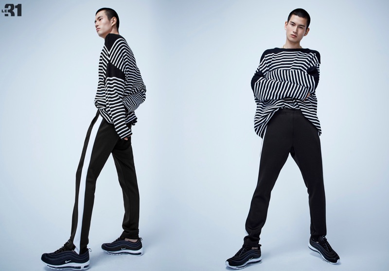 Making a case for stripes, Kohei Takabatake wears a LE 31 loose striped knit sweater with retro track pants and Nike Air Max 97 sneakers.