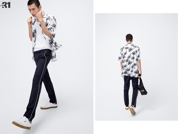 Embracing a cool vibe, Kohei Takabatake rocks a LE 31 printed camp shirt with piped pants, and a loose tank with white Simons leather sneakers.