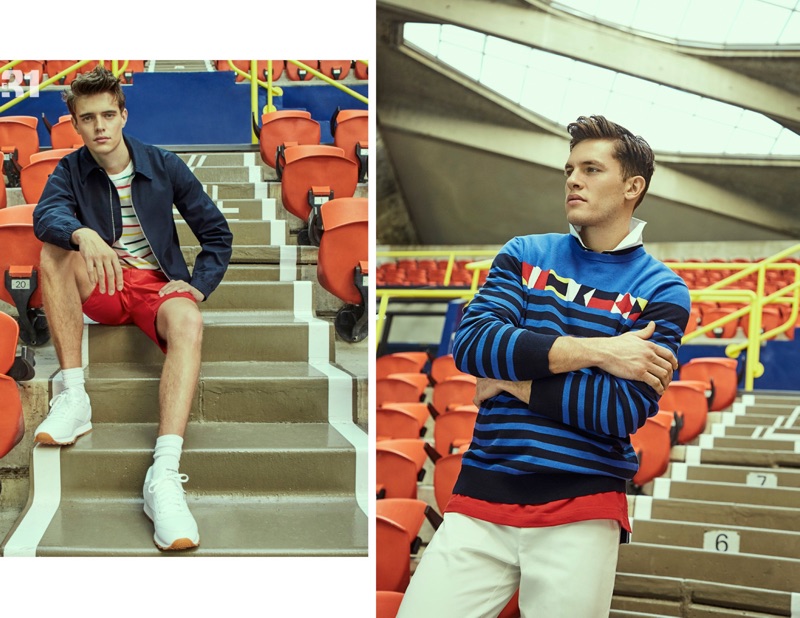 Left: Jordy Baan wears a LE 31 Harrington jacket, striped boat tee, and red Bermudas with Reebok Classic sneakers. Right: Simon Malenfant dons a LE 31 nautical flag sweater and colorblock polo shirt.