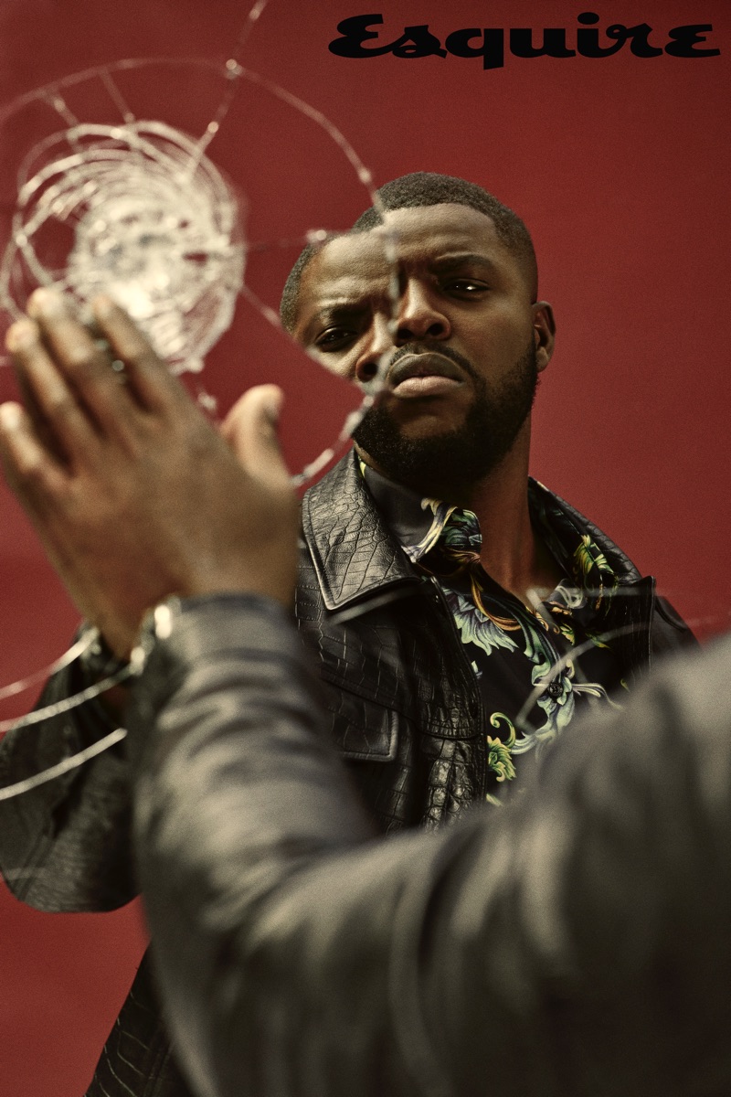 Winston Duke sports a leather jacket by Tom Ford with a Versace shirt.