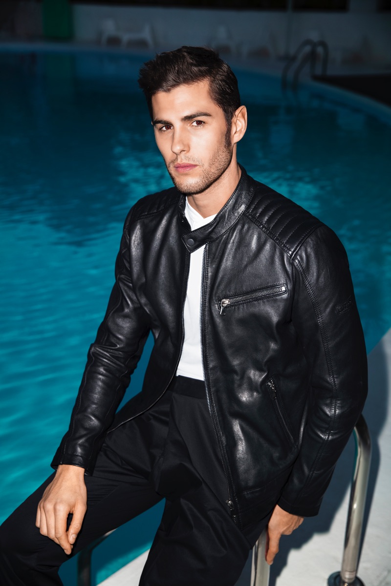 Appearing poolside, René Grincourt rocks a leather jacket for Wormland's spring-summer 2019 campaign.