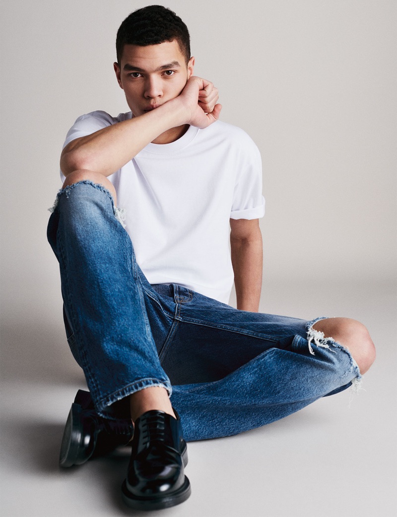 Louis Griffiths wears denim jeans with a white tee from Zara Man.