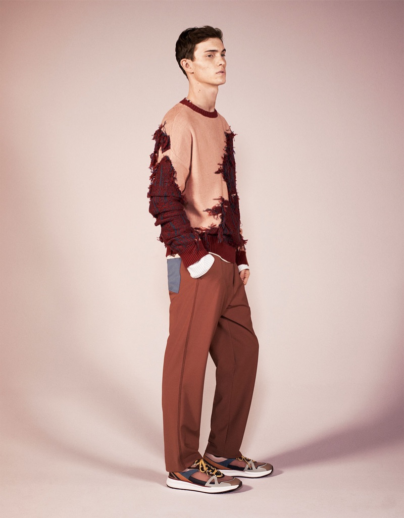 Making a fashion statement, Luc Defont-Saviard models Zara's deconstructed sweater, trousers, and sneakers from its spring-summer 2019 studio collection.