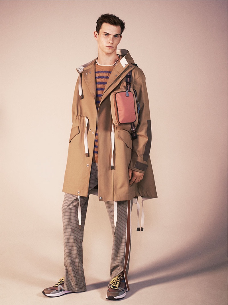 Embracing a fashionable cool, Luc Defont-Saviard sports a parka, striped sweater, sartorial track pants, belt bag, and sneakers from Zara's spring-summer 2019 studio collection.