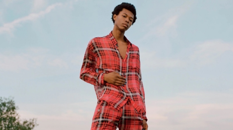 Model Morocco wears a 424 plaid silk chiffon oversized shirt and jogger pants with Ales Grey leather sneakers.