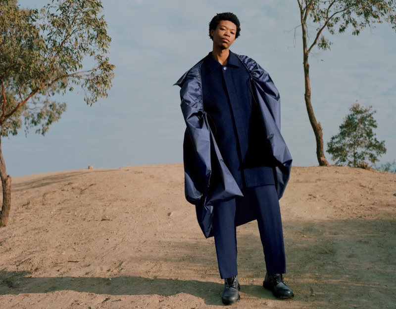 Making an oversized statement, Morocco rocks a Y/Project anorak-overlay wool-cashmere coat and trousers with an ISAIA car coat and suede lace-up boots.