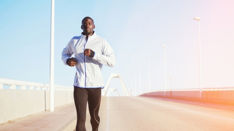 Black Man in Workout Clothes Running on Bridge
